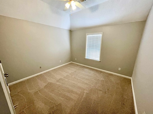 carpeted spare room with lofted ceiling and ceiling fan