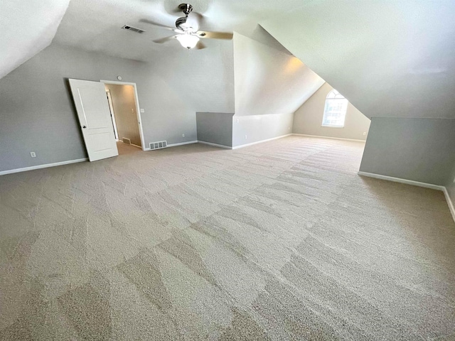 additional living space featuring vaulted ceiling, carpet floors, a textured ceiling, and ceiling fan