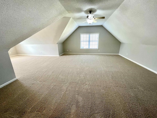 bonus room featuring carpet floors, a textured ceiling, and vaulted ceiling