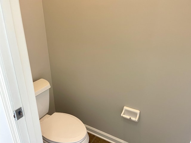 bathroom with toilet and tile patterned flooring