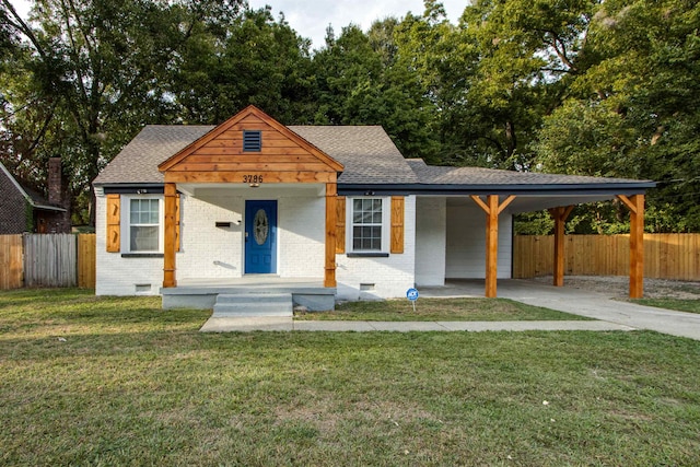 view of front of property with a front lawn, a carport, and covered porch