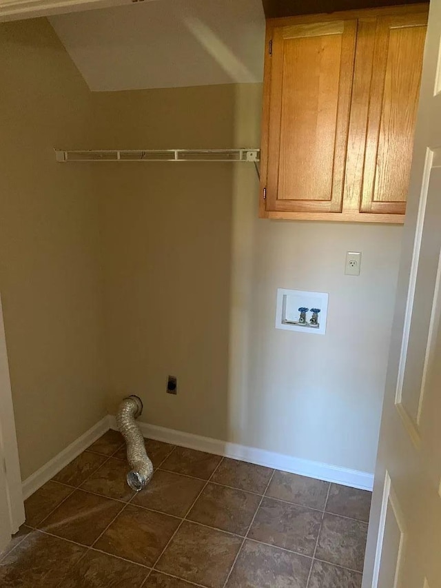 laundry room with washer hookup, cabinets, hookup for an electric dryer, and dark tile patterned flooring