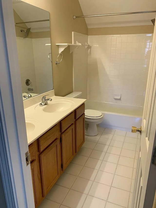 full bathroom with tiled shower / bath combo, vanity, tile patterned floors, and toilet