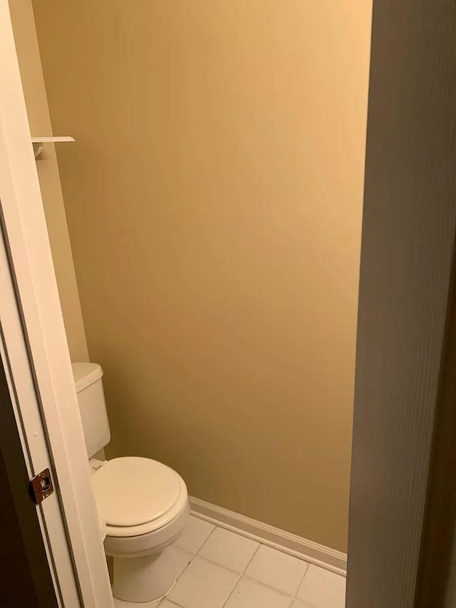 bathroom with toilet and tile patterned flooring