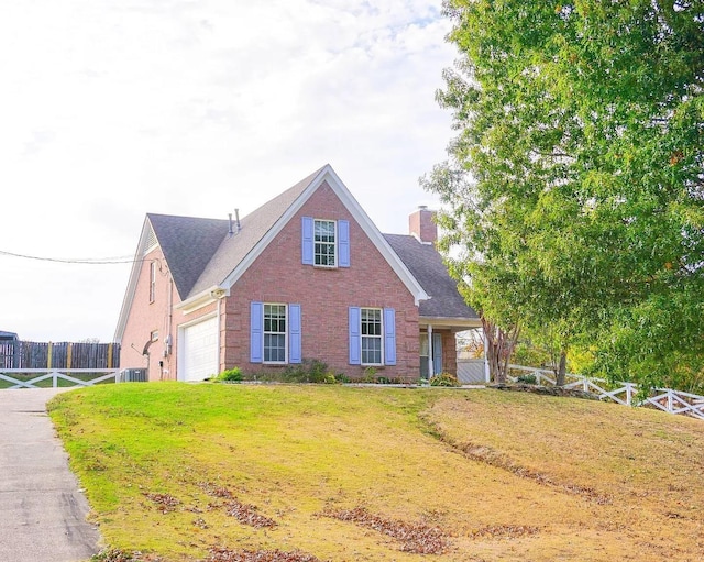 view of front of house with a garage and a front yard