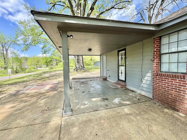 view of patio / terrace featuring entry steps and an attached carport