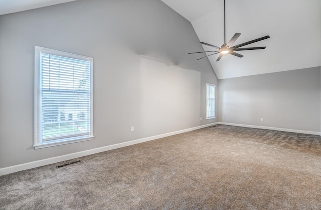 carpeted spare room featuring ceiling fan and high vaulted ceiling