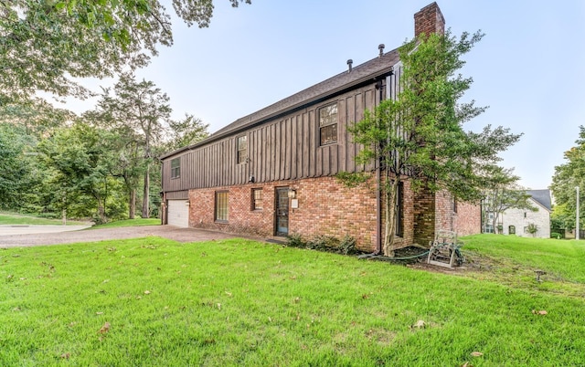 view of home's exterior featuring a yard and a garage