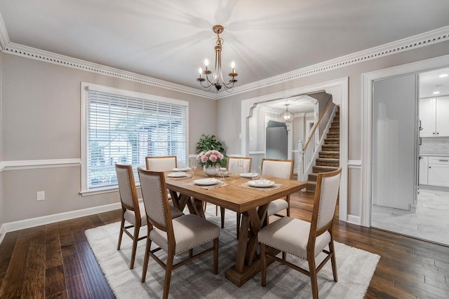 dining space featuring ornamental molding, dark hardwood / wood-style floors, and a chandelier