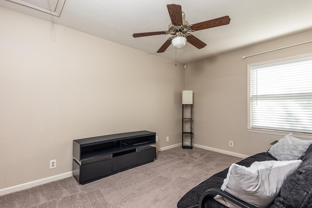 sitting room featuring light carpet and ceiling fan