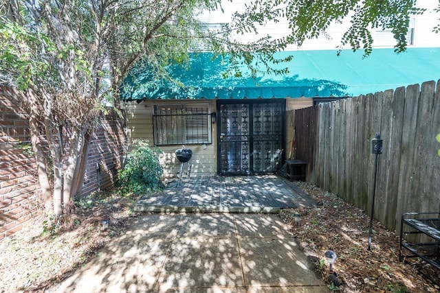 view of gate featuring a patio area