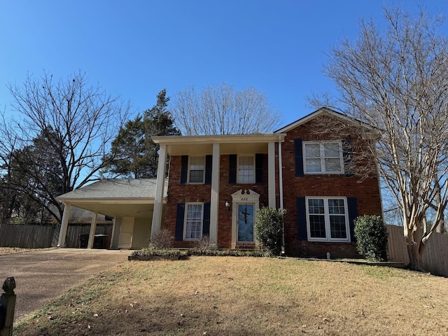 view of front of property with a front yard and a carport