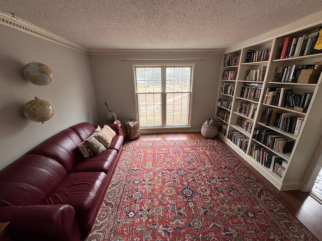 living area with wood-type flooring and a textured ceiling