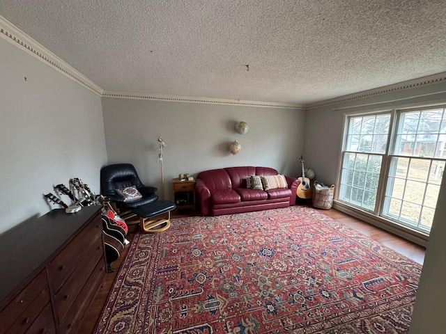 unfurnished living room featuring hardwood / wood-style floors, ornamental molding, and a textured ceiling