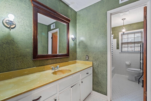 bathroom featuring tile patterned flooring, vanity, and toilet