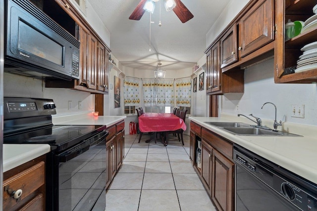 kitchen with sink, black appliances, a textured ceiling, and light tile patterned flooring