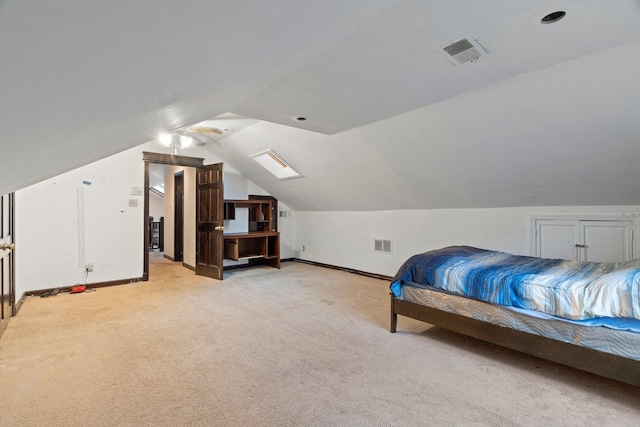 bedroom featuring vaulted ceiling and light carpet