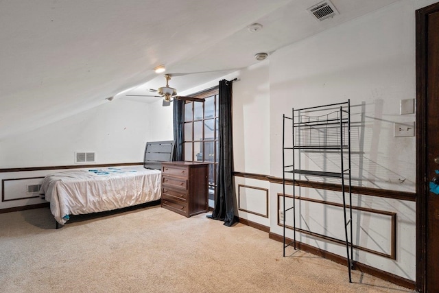 bedroom with vaulted ceiling and light colored carpet