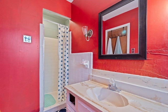 bathroom featuring vanity and curtained shower