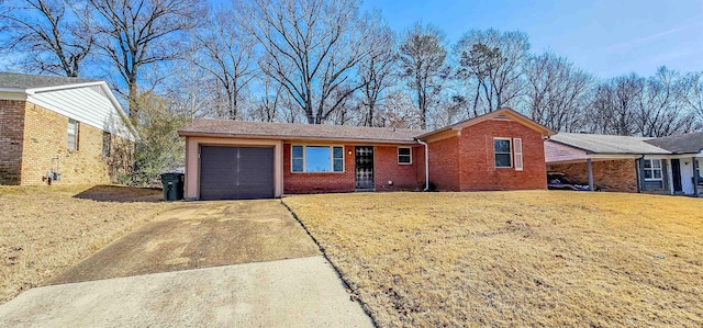 single story home featuring a garage and a front lawn