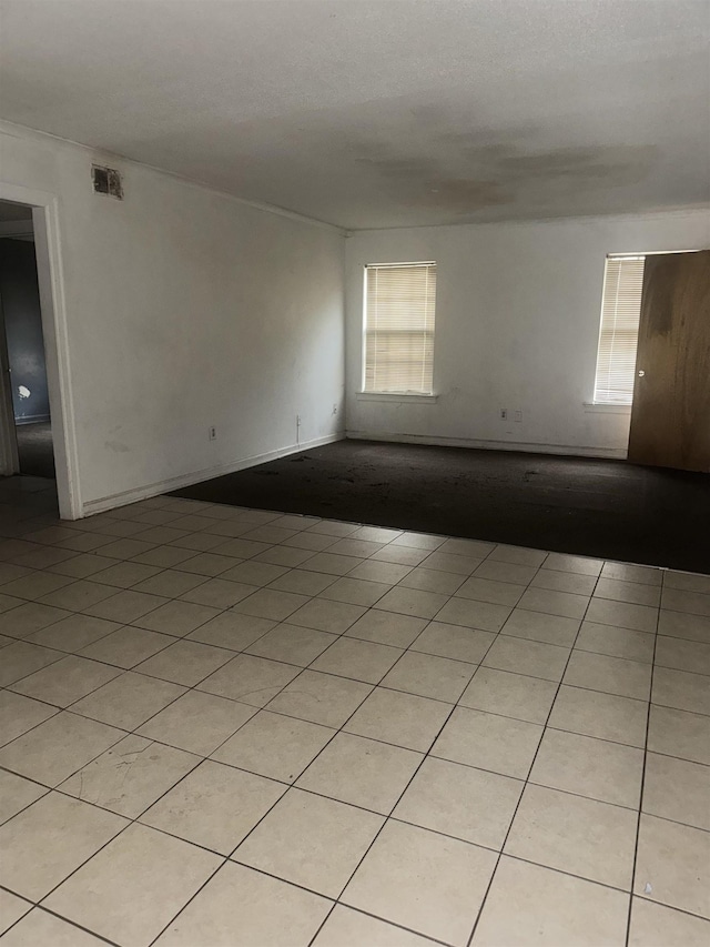 spare room with light tile patterned floors