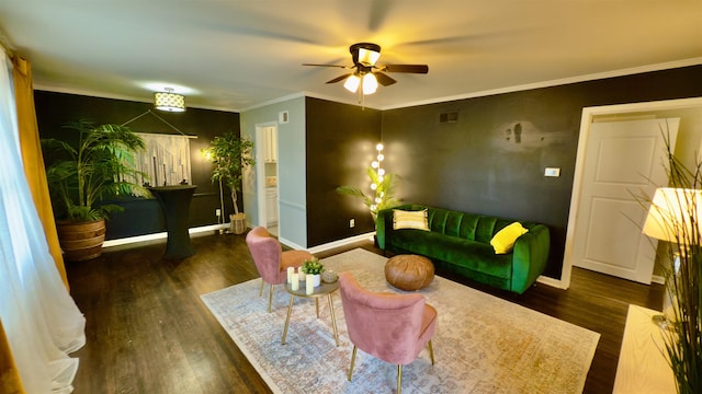 living room featuring crown molding, ceiling fan, and dark hardwood / wood-style flooring