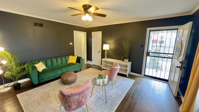 living room featuring ornamental molding, ceiling fan, and dark hardwood / wood-style flooring