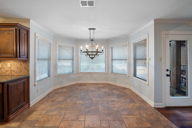 unfurnished dining area featuring an inviting chandelier and crown molding