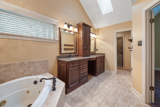 bathroom with vanity, vaulted ceiling with skylight, tile patterned floors, and plus walk in shower