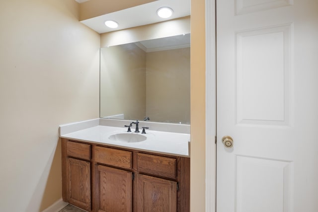 bathroom featuring vanity and ornamental molding