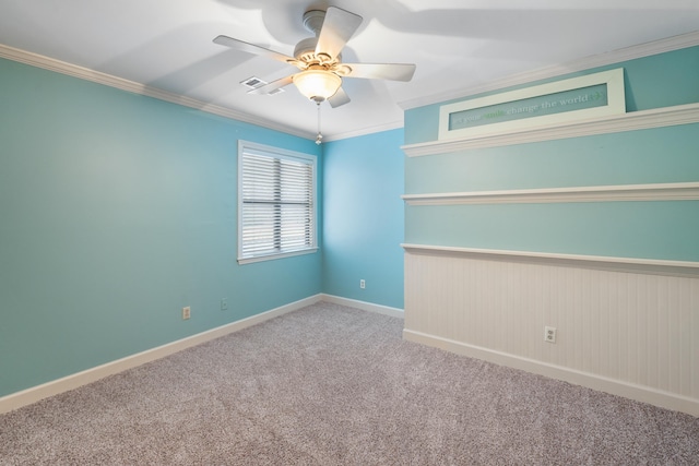 carpeted empty room with ornamental molding and ceiling fan