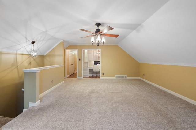 additional living space with vaulted ceiling, carpet flooring, and ceiling fan with notable chandelier