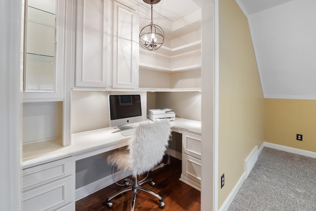 office with vaulted ceiling, a chandelier, built in desk, and carpet floors