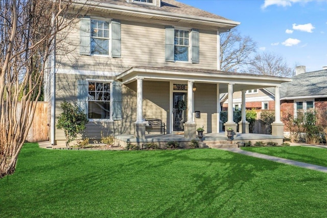 view of front of home with a porch and a front yard