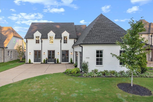 french provincial home featuring a front lawn