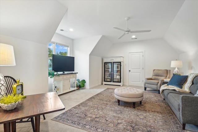 living room with lofted ceiling, light colored carpet, and ceiling fan