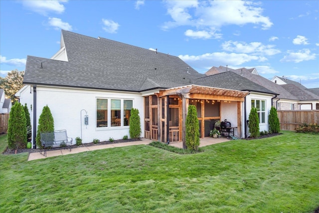 back of property featuring a pergola, a lawn, and a patio