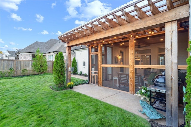 exterior space featuring a pergola, a lawn, and a patio area