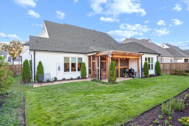 rear view of house featuring a yard, a pergola, and a patio