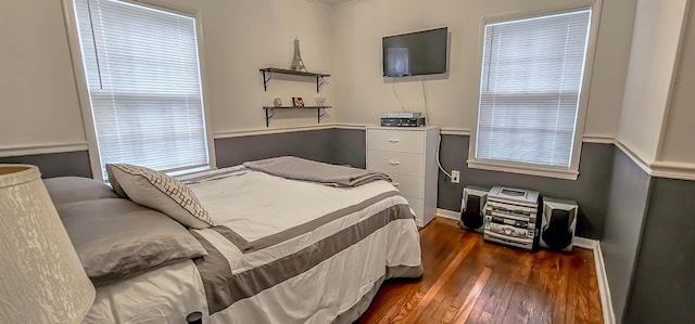 bedroom with dark hardwood / wood-style floors