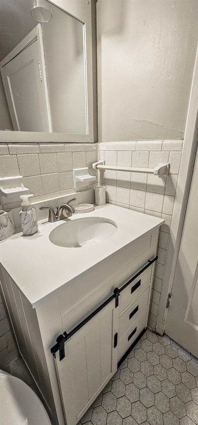 bathroom featuring tile walls, vanity, and tile patterned flooring