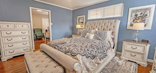 bedroom with crown molding and dark hardwood / wood-style floors