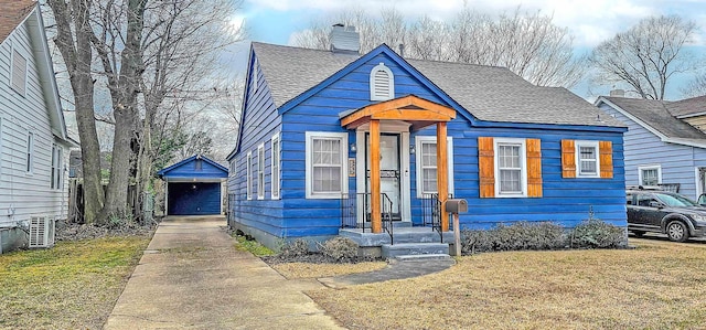 bungalow with central AC unit and a front lawn