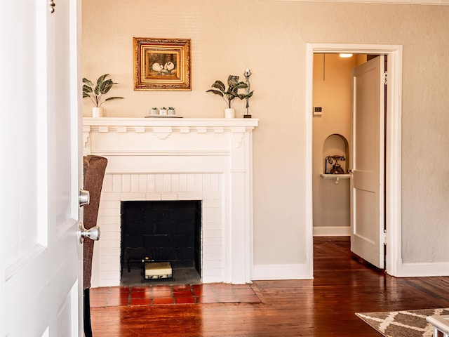 room details with hardwood / wood-style flooring and a brick fireplace