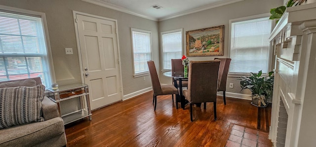 dining area with ornamental molding and dark hardwood / wood-style floors