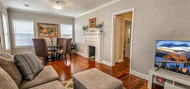 living room featuring crown molding, dark wood-type flooring, and a textured ceiling