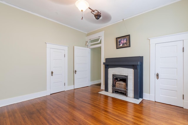 unfurnished living room featuring crown molding and wood-type flooring