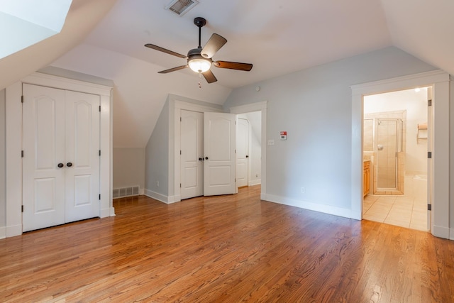 additional living space featuring ceiling fan, lofted ceiling, and light hardwood / wood-style floors