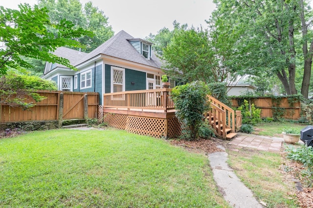 back of house with a wooden deck and a yard