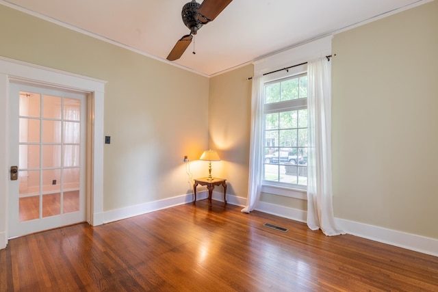 empty room featuring crown molding, ceiling fan, and dark hardwood / wood-style flooring